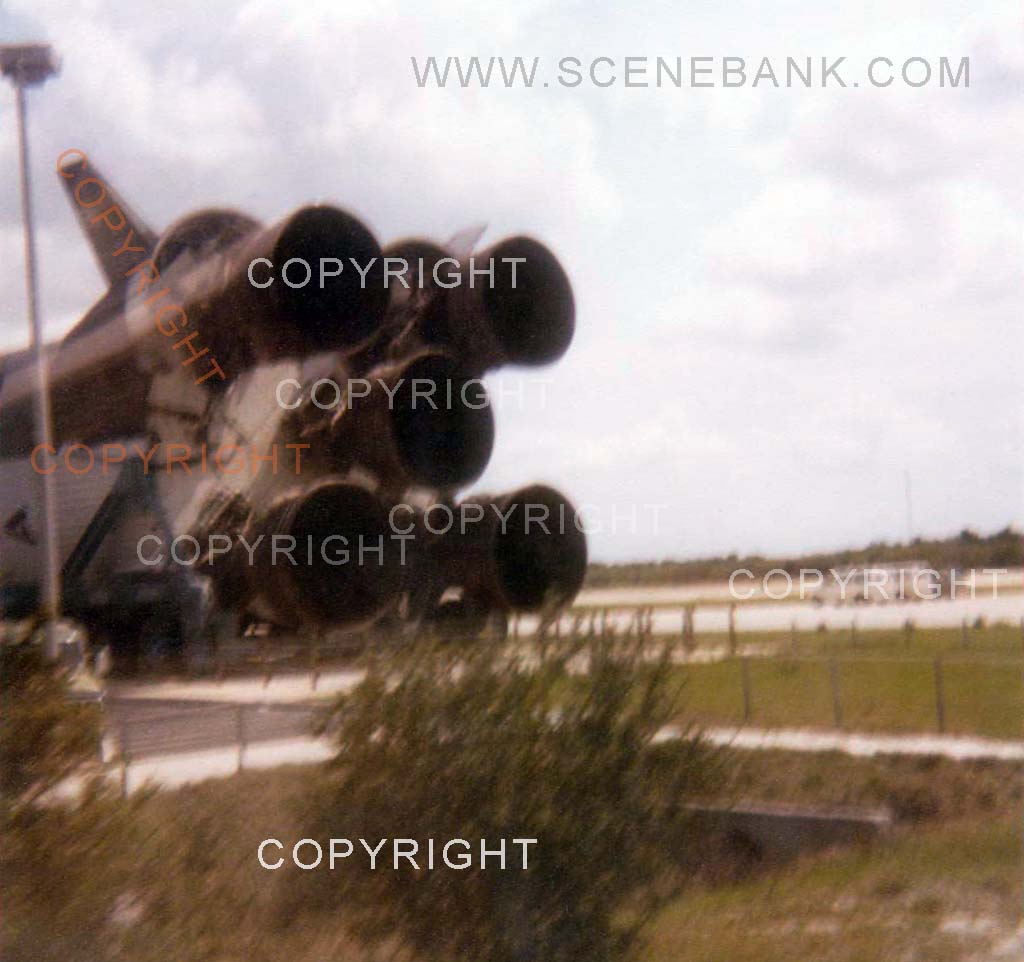 1979 photo of a NASA Saturn V rocket on display - laying on its side - 5 main engines on lower rocket stage - seen through window of tour bus at Cape Canaveral, Florida, USA